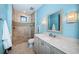 Bright bathroom with a walk-in shower, single sink vanity, and light blue walls at 3901 Bayshore Ne Blvd, St Petersburg, FL 33703
