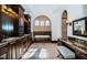 Luxury bathroom featuring dark wood cabinets, granite countertops, and a tiled tub with arched windows at 3901 Bayshore Ne Blvd, St Petersburg, FL 33703