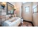 Bathroom featuring brick wall, trough style sink, stone flooring, and decorative lighting at 3901 Bayshore Ne Blvd, St Petersburg, FL 33703