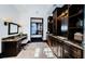 Well-lit bathroom featuring custom dark wood cabinets with granite countertops and tiled floors at 3901 Bayshore Ne Blvd, St Petersburg, FL 33703