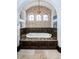 Elegant bathtub with beautiful tile backsplash and arched alcove with three windows and natural light at 3901 Bayshore Ne Blvd, St Petersburg, FL 33703