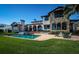 Stately home showcases stone accents, a large pool, a fire pit, and outdoor seating for ultimate relaxation at 3901 Bayshore Ne Blvd, St Petersburg, FL 33703