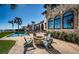 Beautiful backyard featuring a pool, waterfront views, stone accents, and an outdoor fire pit with seating at 3901 Bayshore Ne Blvd, St Petersburg, FL 33703