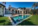 Expansive backyard features a stunning pool, a sprawling lawn, and a luxurious Mediterranean-style home at 3901 Bayshore Ne Blvd, St Petersburg, FL 33703