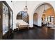 Grand foyer featuring arched doorways, dark hardwood floors, decorative lighting, and a staircase with decorative tile risers at 3901 Bayshore Ne Blvd, St Petersburg, FL 33703