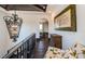Upstairs hallway featuring dark wood floors, an ornate chandelier, and an arched doorway to the dining area at 3901 Bayshore Ne Blvd, St Petersburg, FL 33703