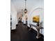 Hallway featuring arches, dark hardwood floors, decorative light fixtures, and a painting at 3901 Bayshore Ne Blvd, St Petersburg, FL 33703