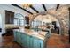 Gourmet kitchen with stone arch, custom cabinets, granite counters, and terracotta tile flooring at 3901 Bayshore Ne Blvd, St Petersburg, FL 33703