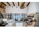 Spacious living room with a stone fireplace, high ceilings with wood beams, and views of the water at 3901 Bayshore Ne Blvd, St Petersburg, FL 33703