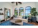 Bright living room with large windows offering water views, tile floor, and comfortable seating at 3901 Bayshore Ne Blvd, St Petersburg, FL 33703