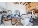 Bright living room with a stone fireplace, high ceilings, and an open floor plan leading to the kitchen and dining area at 3901 Bayshore Ne Blvd, St Petersburg, FL 33703