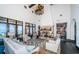 Spacious living room with a stone fireplace, high ceilings with wood beams, and views of the waterfront at 3901 Bayshore Ne Blvd, St Petersburg, FL 33703