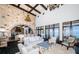 Open-concept living space with a stone accent wall, high ceilings with wood beams, and water views at 3901 Bayshore Ne Blvd, St Petersburg, FL 33703