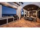 Covered outdoor kitchen at twilight with tile flooring, seating, and stunning water views at 3901 Bayshore Ne Blvd, St Petersburg, FL 33703