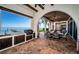 Outdoor kitchen and dining area with water views, tile flooring, and an arched ceiling at 3901 Bayshore Ne Blvd, St Petersburg, FL 33703