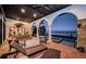 Stunning outdoor living space with an ocean view, covered seating area, and a beautiful stone-clad structure at 3901 Bayshore Ne Blvd, St Petersburg, FL 33703