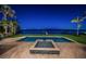 Picturesque waterfront pool and spa with swaying palm trees, offering a tranquil escape at nighttime at 3901 Bayshore Ne Blvd, St Petersburg, FL 33703