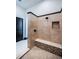 Tiled shower with a built-in niche, a seat, and black hardware including rain shower and wand at 3901 Bayshore Ne Blvd, St Petersburg, FL 33703