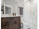 Bathroom featuring dark wood vanity with quarts countertop, tiled shower and glass door at 4224 W Kensington Ave, Tampa, FL 33629