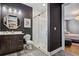 Modern bathroom with walk-in shower, dark gray walls, and decorative mirror at 4224 W Kensington Ave, Tampa, FL 33629