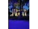 Nighttime view of the two-story home showcasing its well-lit facade and landscaped yard at 4224 W Kensington Ave, Tampa, FL 33629