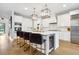 Spacious white kitchen featuring an island with seating, wine cooler, and modern appliances at 4224 W Kensington Ave, Tampa, FL 33629