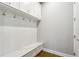 Mudroom with white cabinetry, coat hooks, and a built-in bench at 4224 W Kensington Ave, Tampa, FL 33629