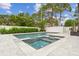 Sparkling pool and spa with stone decking and privacy fence at 4224 W Kensington Ave, Tampa, FL 33629