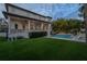 Expansive backyard with well-maintained lawn, pool, and covered outdoor seating area at 5020 W Dickens Ave, Tampa, FL 33629