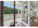 View of a spacious balcony with a pool and lush tropical foliage just beyond the patio at 5020 W Dickens Ave, Tampa, FL 33629