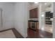 Bar area featuring wood cabinets, a wine fridge, dark wood floors, and granite countertops at 5020 W Dickens Ave, Tampa, FL 33629
