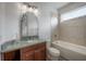 Light-filled bathroom offers vanity with sleek marble countertop and a soaking tub with tiled accents at 5020 W Dickens Ave, Tampa, FL 33629