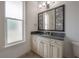 Bathroom with decorative framed mirror and frosted glass window at 5020 W Dickens Ave, Tampa, FL 33629