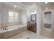 Bright bathroom featuring a soaking tub, vanity with green marble countertop, and tiled floors at 5020 W Dickens Ave, Tampa, FL 33629