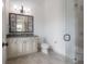 Bathroom with decorative framed mirror, marble countertop and stone tile flooring at 5020 W Dickens Ave, Tampa, FL 33629