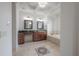 Luxurious bathroom with dual vanities, a soaking tub, decorative tile floor, and elegant fixtures at 5020 W Dickens Ave, Tampa, FL 33629