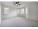 Bright bedroom with three windows and a ceiling fan at 5020 W Dickens Ave, Tampa, FL 33629