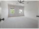 Expansive, light-filled bedroom features neutral carpeting and a ceiling fan at 5020 W Dickens Ave, Tampa, FL 33629