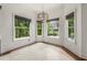Corner breakfast nook with white walls, tile floors, and windows overlooking lush tropical foliage at 5020 W Dickens Ave, Tampa, FL 33629