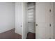 Spacious walk-in closet with custom shelving and ample storage, with matching hardwood floors nearby at 5020 W Dickens Ave, Tampa, FL 33629