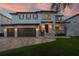 Stunning home facade with three-car garage, stone accents, and well-maintained landscaping at 5020 W Dickens Ave, Tampa, FL 33629