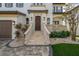 Charming two-story home with stone steps, stucco facade, and a landscaped front yard at 5020 W Dickens Ave, Tampa, FL 33629
