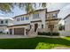 Elegant home with a three-car garage, lush green lawn, and beautiful curb appeal at 5020 W Dickens Ave, Tampa, FL 33629