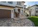 Charming home featuring a three-car garage, stone accents, and manicured landscaping at 5020 W Dickens Ave, Tampa, FL 33629