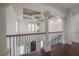 Elegant foyer with hardwood floors, decorative columns, wrought iron railing, and a stylish chandelier at 5020 W Dickens Ave, Tampa, FL 33629