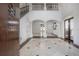 Elegant foyer with soaring ceilings, a staircase, and marble floors, showcasing the home's grandeur at 5020 W Dickens Ave, Tampa, FL 33629