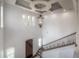 Elegant foyer with a soaring ceiling, decorative chandelier, and staircase with ornate iron railings at 5020 W Dickens Ave, Tampa, FL 33629