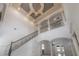 Expansive foyer with tall ceilings, decorative columns, wrought iron railing, and a chandelier at 5020 W Dickens Ave, Tampa, FL 33629