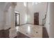Grand foyer with soaring ceilings, decorative columns, and a stunning stone tiled floor with black inlays at 5020 W Dickens Ave, Tampa, FL 33629