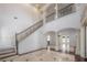 Grand foyer with high ceilings, ornate columns, iron railing, and marble floors, exuding luxury and style at 5020 W Dickens Ave, Tampa, FL 33629